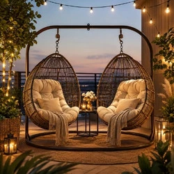 Double hanging egg chair outdoor reading nook with fairy lights, weatherproof cushions, and cozy balcony seating