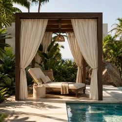 Poolside cabana reading nook with weatherproof curtains, lounge chair, shaded outdoor relaxation area, and luxury backyard design
