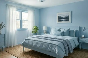 Powder blue bedroom walls with frosted blue furniture creating an airy monochromatic interior